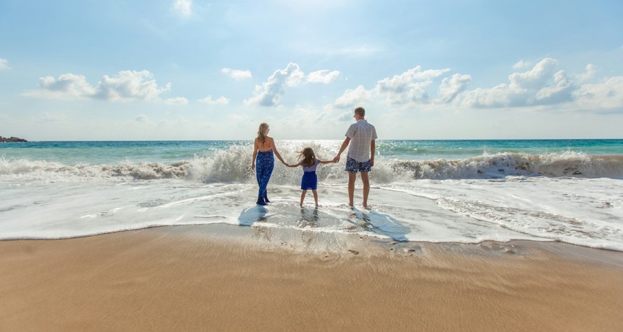 Family holding hands at the beach